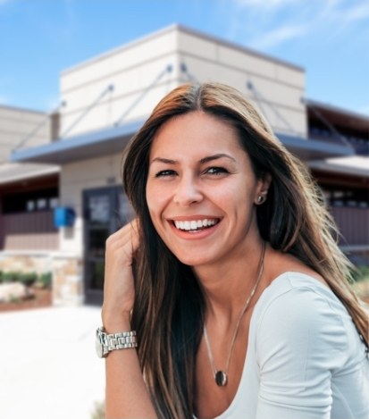 Woman smiling outside of dental office in Norman Oklahoma