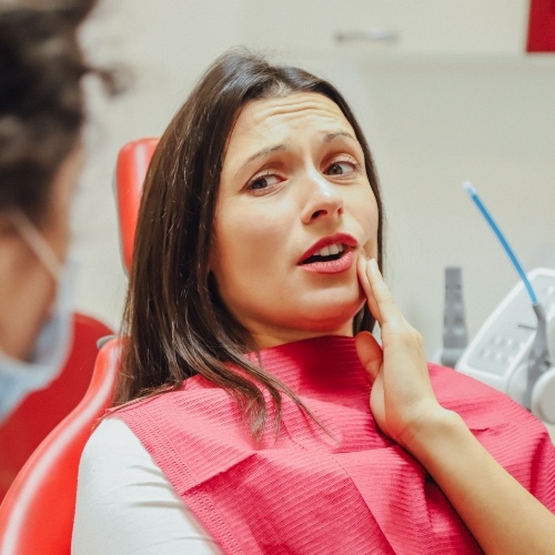 Woman with toothache talking to her dentist