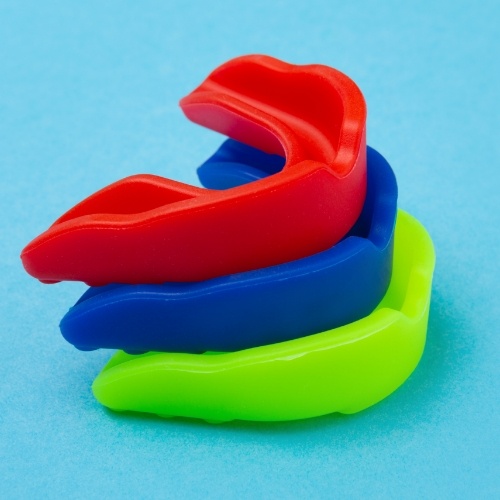 Green blue and red mouthguard stacked on top of each other