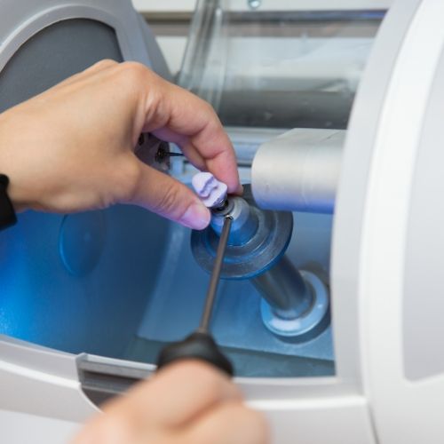 Dental team member using a one visit dental crown machine