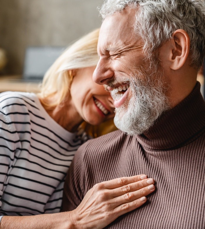 Senior man and woman with dental implants in Norman laughing together