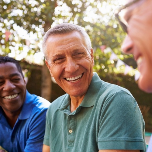 Group of men laughing together outdoors