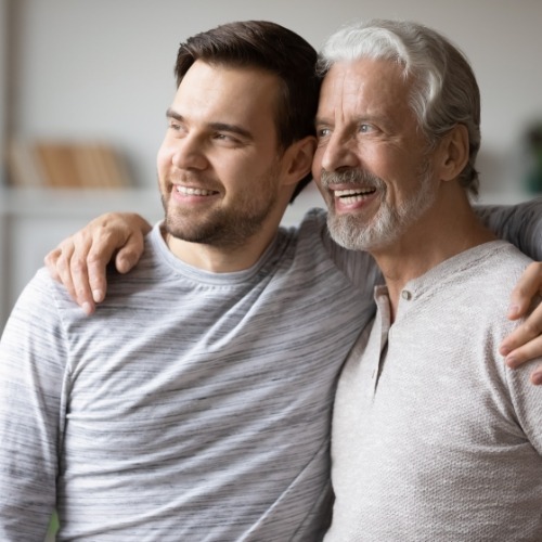 Man and his father hugging from the side