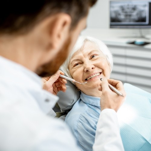 Senior woman smiling at her dentist before a dental exam