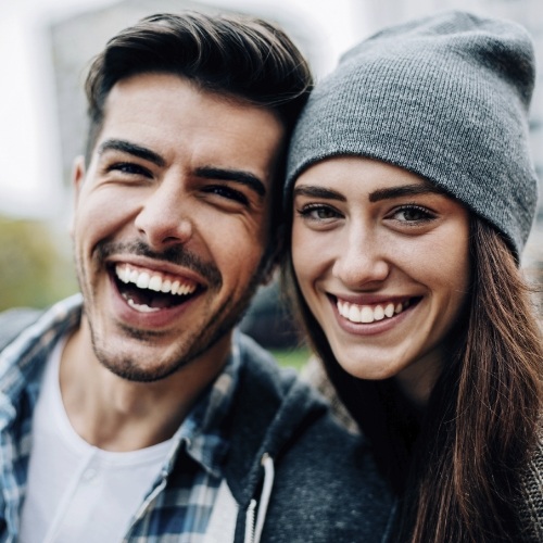 Laughing man with woman wearing beanie