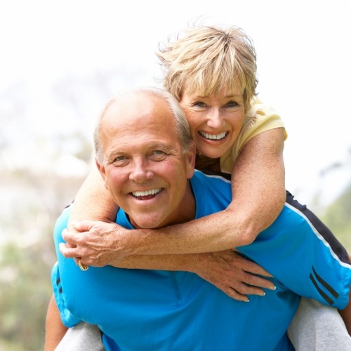 Man giving woman a piggyback ride outdoors