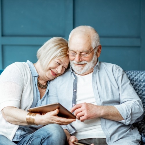 Senior man and woman using tablet together