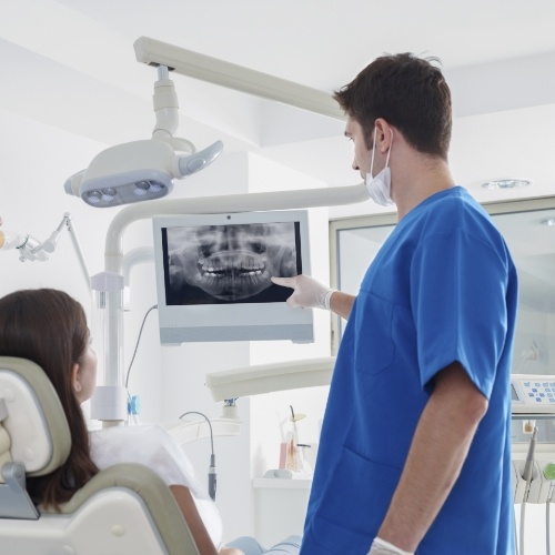 Dentist showing a patient their digital dental x rays in Norman