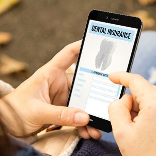 Patient looking at dental insurance information on phone