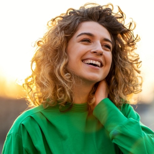 Young woman wearing green hoodie outdoors