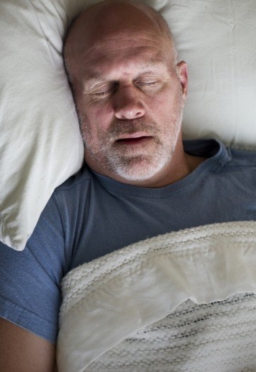 Senior man in gray tee shirt sleeping