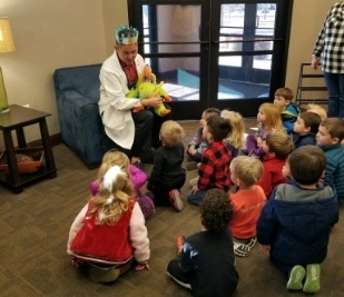 Doctor Carmen giving a presentation to a classroom of kids