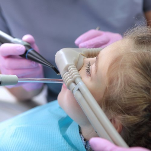 Closeup of a young woman getting dental work done with nitrous oxide sedation