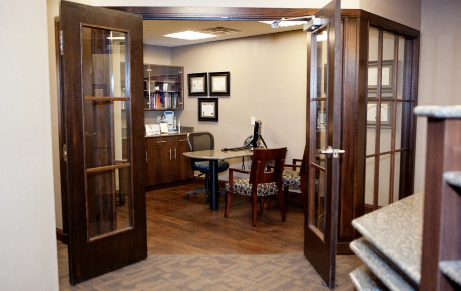 Wooden doors opening to reveal dental consultation room