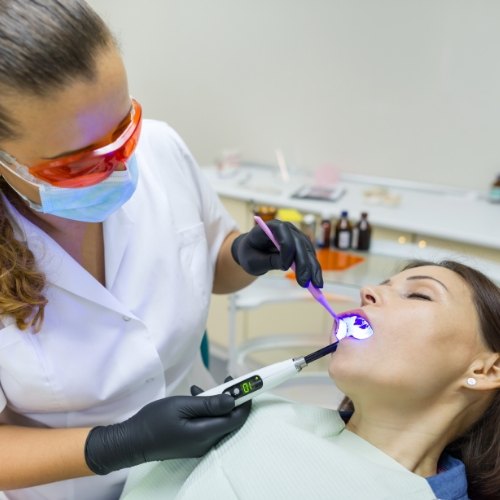 Dental team member examining the mouth of a patient
