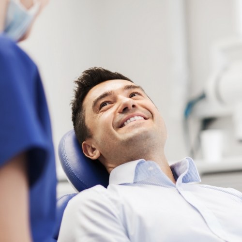 Man smiling at his dentist during a dental checkup