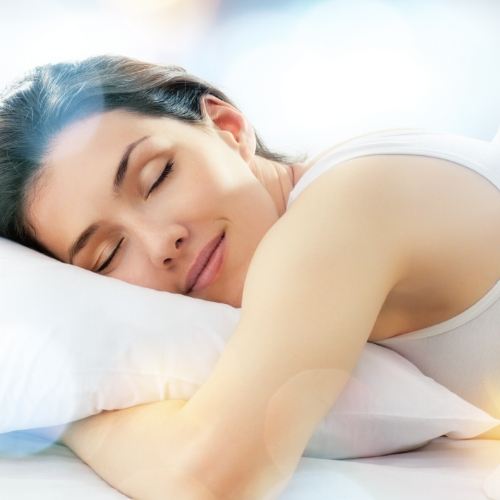 Woman sleeping soundly while hugging pillow