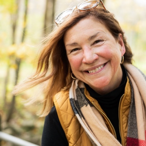 Older woman with scarf smiling outdoors