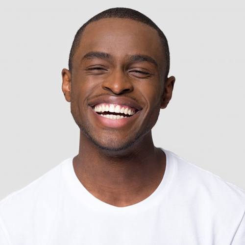 Man smiling brightly on white background