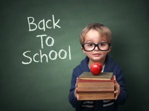 blonde headed boy carrying books