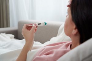 woman looking at thermometer