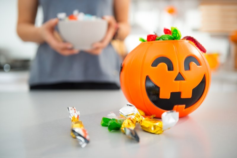 Close up of plastic pumpkin filled with candy