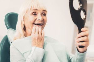 older woman happy with new dentures