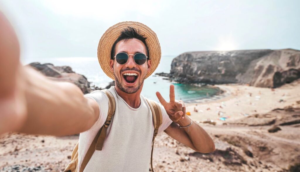 A man smiling on a beach